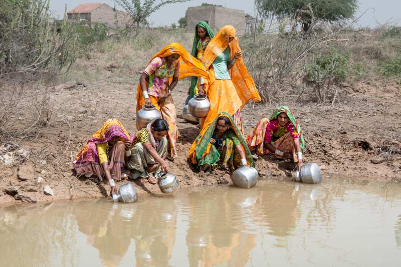 Human Right to Water in Kutch district, Gujarat - Collecting water for drinking and personal use from a visibly muddy pond on village outskirts